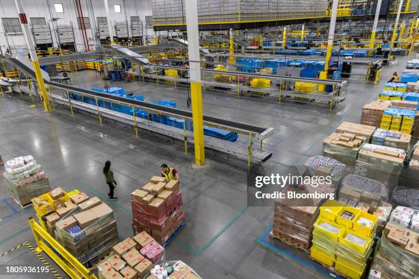 An worker prepares packages for shipping at an Amazon Fulfillment center on Cyber Monday in Robbinsville, New Jersey, US, on Monday, Nov. 27, 2023....