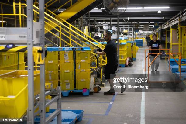 Workers prepare packages for shipping at an Amazon Fulfillment center on Cyber Monday in Robbinsville, New Jersey, US, on Monday, Nov. 27, 2023. An...