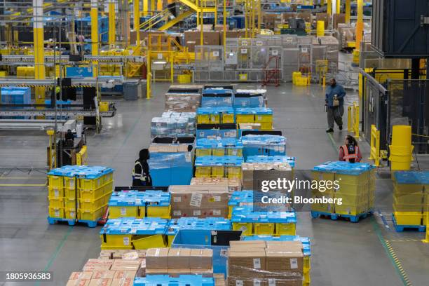 Workers prepare packages for shipping at an Amazon Fulfillment center on Cyber Monday in Robbinsville, New Jersey, US, on Monday, Nov. 27, 2023. An...