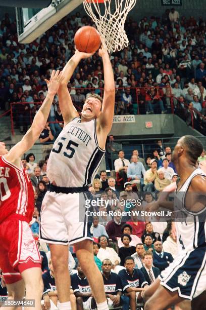 University of Connecticut basketball player Dan Cyrulik goes up strong while shooting from the baseline, Storrs, Connecticut, 1992.