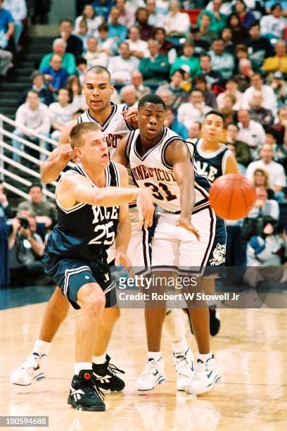 University of Connecticut's Brian Fair, right, and Donny Marshall, center, force a turnover against Yale, Storrs, Connecticut, 1994.