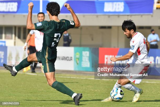 Ehson Panshanbe of Tajikistan tackles the ball from Mohib Ullah of Pakistan during the 2026 FIFA World Cup AFC Qualifier Group G match between...