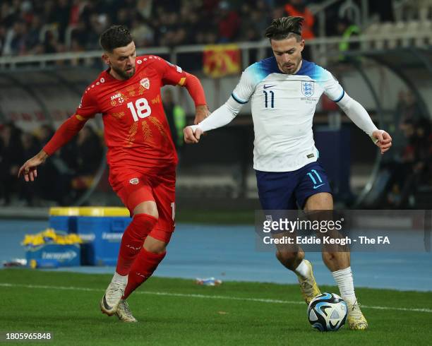Jack Grealish of England battles for possession with Isnik Alimi of North Macedonia during the UEFA EURO 2024 European qualifier match between North...