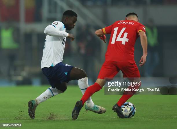 Marc Guehi of England battles for possession with Bojan Dimoski of North Macedonia during the UEFA EURO 2024 European qualifier match between North...