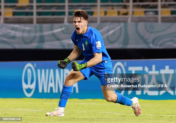 Taha Benrhozil of Morocco celebrates after saving a penalty in the penalty shootout during the FIFA U-17 World Cup Round of 16 match between Morocco...