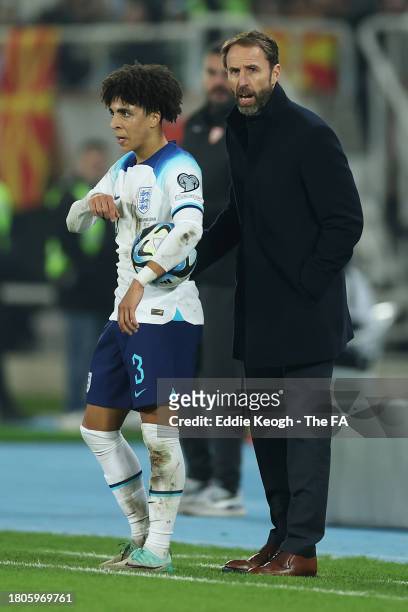 Rico Lewis of England looks on alongside Gareth Southgate, Head Coach of England, during the UEFA EURO 2024 European qualifier match between North...