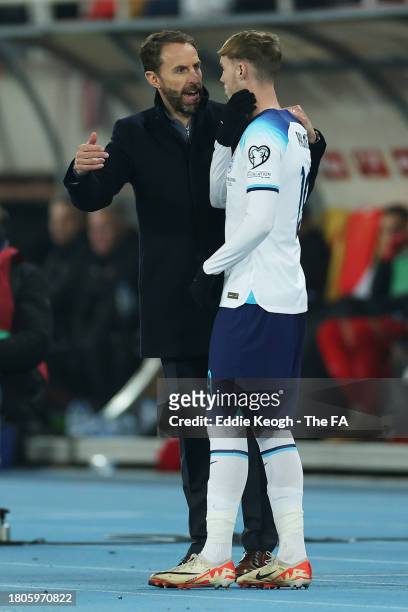 Gareth Southgate, Head Coach of England, speaks with Cole Palmer of England during the UEFA EURO 2024 European qualifier match between North...