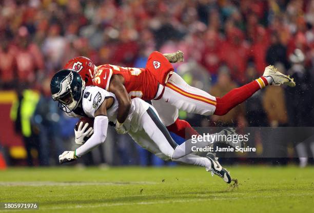 DeVonta Smith of the Philadelphia Eagles is tackled by Jaylen Watson of the Kansas City Chiefs in the second half at GEHA Field at Arrowhead Stadium...