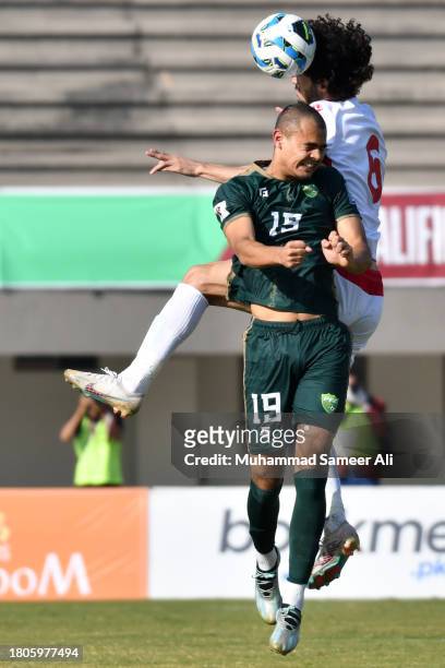 Ehson Panshanbe of Tajikistan tackles the ball from Mohib Ullah of Pakistan during the 2026 FIFA World Cup AFC Qualifier Group G match between...