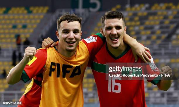 Abdelhamid Maali and Ayman Ennair of Morocco celebrate following the team's victory in the penalty shootout during the FIFA U-17 World Cup Round of...