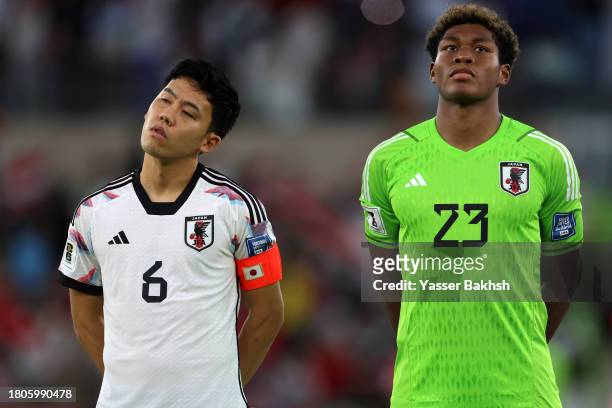 Wataru Endo and Zion Suzuki of Japan stand for the national anthem prior to the FIFA World Cup Asian 2nd qualifier match between Syria and Japan at...