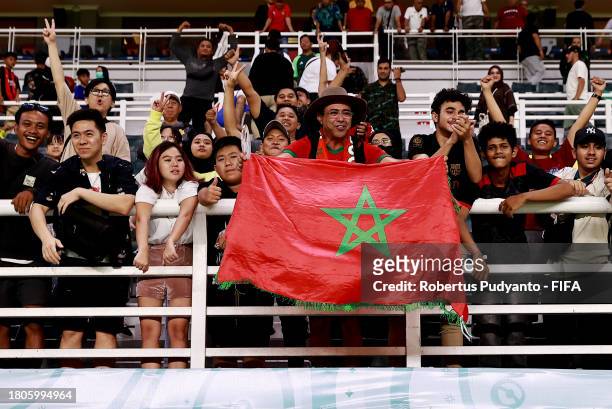 Fans of Morocco celebrate after the FIFA U-17 World Cup Round of 16 match between Morocco and IR Iran at Gelora Bung Tomo Stadium on November 21,...