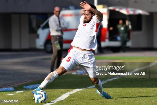 Manucher Safarov of Tajikistan tries to keep the ball out of line during the 2026 FIFA World Cup AFC Qualifier Group G match between Pakistan and...