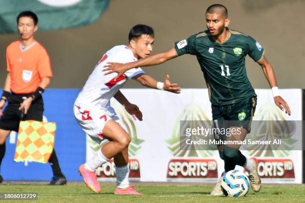 Harun Arrashid Faheem from Pakistan controls the ball against Umarboev Parvizjon of Tajikistan during the 2026 FIFA World Cup AFC Qualifier Group G...