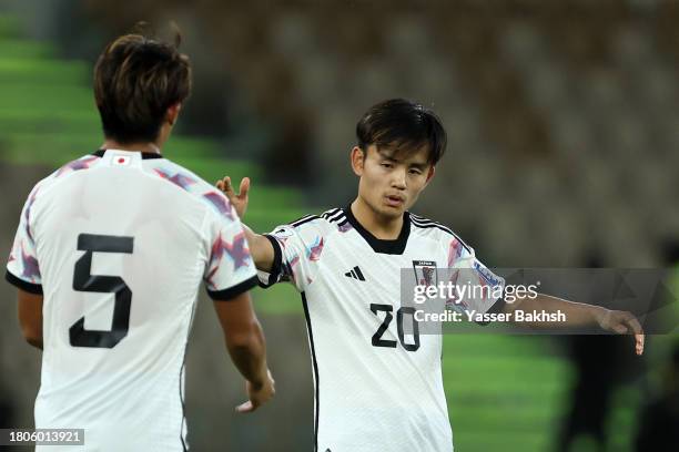 Takefusa Kubo of Japan celebrates with teammate after scoring the team's first goal during the FIFA World Cup Asian 2nd qualifier match between Syria...