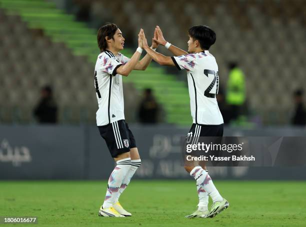 Takefusa Kubo of Japan celebrates with teammate after scoring the team's first goal during the FIFA World Cup Asian 2nd qualifier match between Syria...