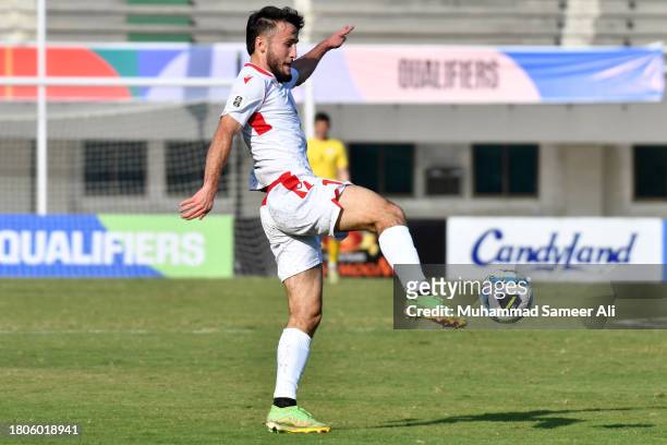 Kamolov Amadoni from Tajikistan kicks the ball during the 2026 FIFA World Cup AFC Qualifier Group G match between Pakistan and Tajikistan at Jinnah...