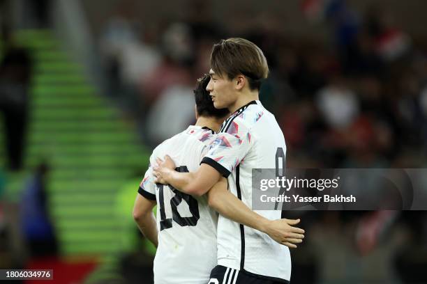 Ayase Ueda of Japan celebrates with Takuma Asano after scoring the team's second goal during the FIFA World Cup Asian 2nd qualifier match between...