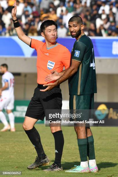 Abdullah Iqbal from Pakistan gets attention from the Referee during the 2026 FIFA World Cup AFC Qualifier Group G match between Pakistan and...