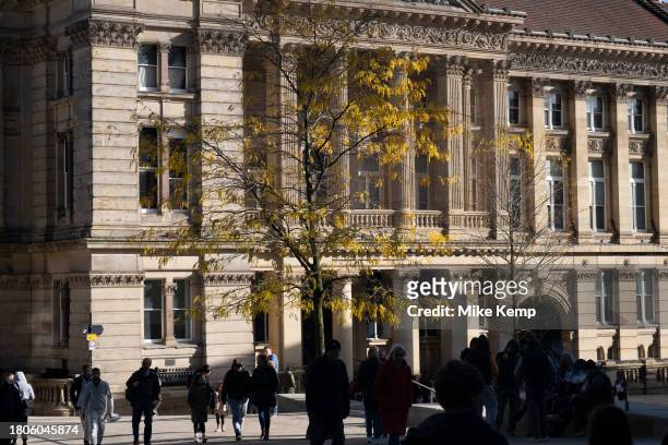 Silhouettes of people walking past the Birmingham City Council Town Hall building in Chamberlain Square in the city centre on 3rd November 2023 in...