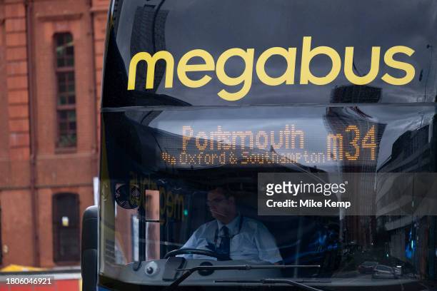 Driver in the driving seat of a Megabus public transport coach on 9th November 2023 in Birmingham, United Kingdom. Megabus is a long-distance...