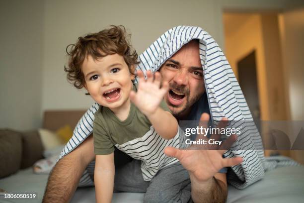 father and toddler play pretend to be animals - tickle monster stock pictures, royalty-free photos & images