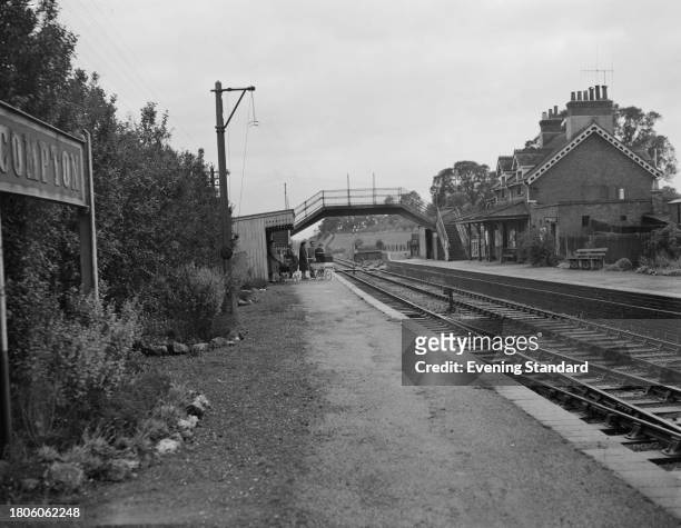 One of the platforms at Compton Railway Station where a small group of people wait for a train in the background, Berkshire, October 24th 1961. The...