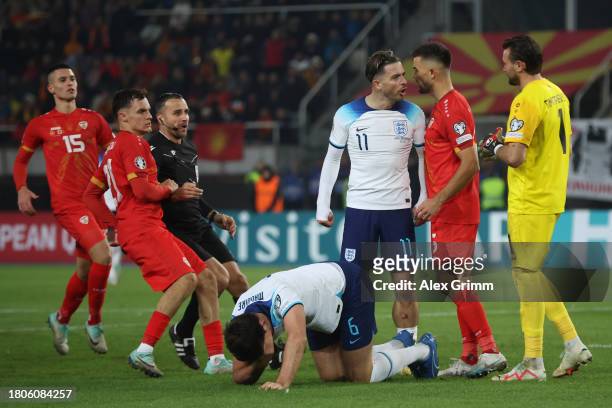 Harry Maguire of England reacts whilst teammate Jack Grealish clashes with Visar Musliu and Stole Dimitrievski of North Macedonia during the UEFA...