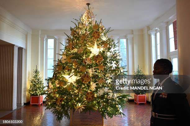 Gold star Christmas tree is seen in the East Wing during the 2023 White House Holiday media preview in Washington, DC, on November 27, 2023. The...
