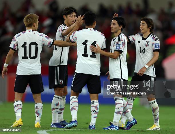 Mao Hosoya of Japan celebrates with teammates after scoring the team's fifth goal during the FIFA World Cup Asian 2nd qualifier match between Syria...