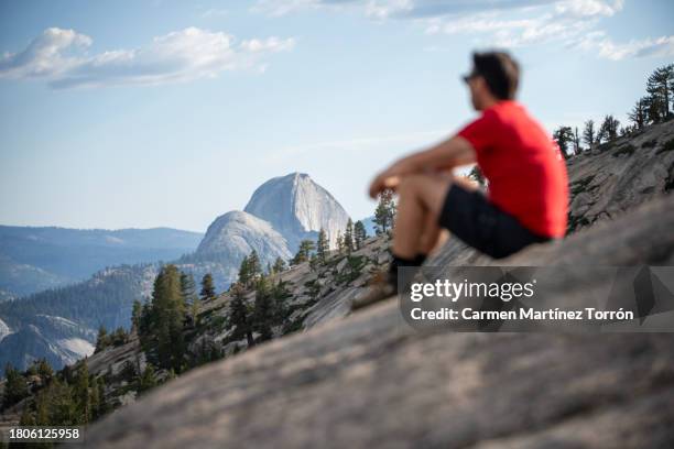 man watching the majesty of the panoramic view of the sunset over half dome, yosemite valley, yosemite national park, california, usa. - half dome stock pictures, royalty-free photos & images