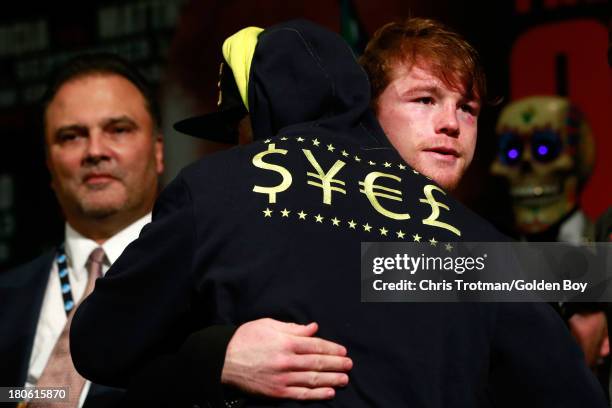 Floyd Mayweather Jr. Hugs Canelo Alvarez at the post fight news conference after Mayweather Jrs. Majority decision victory against Alvarez in their...