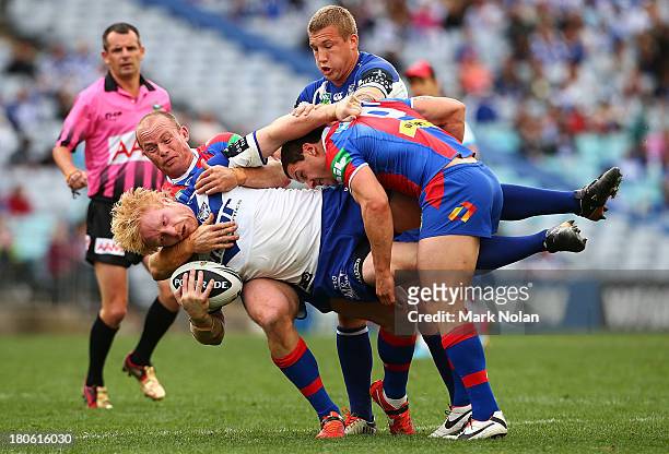 James Graham of the Bulldogs is tackled during the NRL Elimination Final match between the Canterbury Bulldogs and the Newcastle Knights at ANZ...
