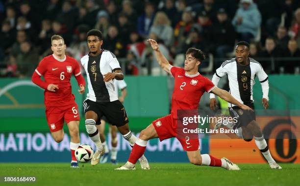Ansgar Knauff of Germany is challenged by Ariel Mosor of Poland during the UEFA Under21 Euro Qualifier match between Germany U21 and Pland U21 at...