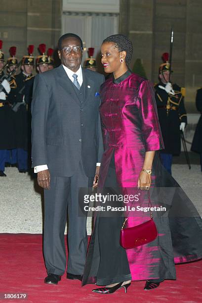 President of Zimbabwe, Robert Mugabe, arrives with his wife to attend a dinner at Elysee Palace February 20, 2003 in Paris, France. A Franco-African...