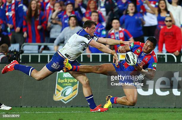 Leilua of the Knights tries to pass while being tackled by Josh Morris of the Bulldogs during the NRL Elimination Final match between the Canterbury...
