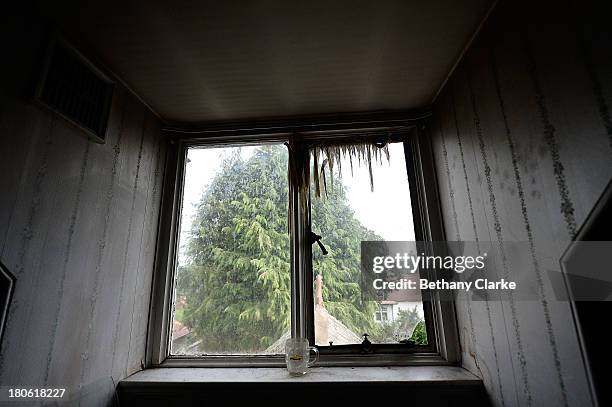 Disintegrated curtains hang in a bedroom in the servants' quarters of Pineheath house on September 4, 2013 in Harrogate, England. The untouched...