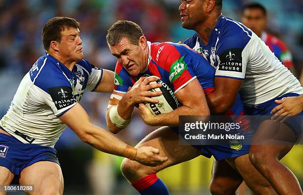 Chris Houston of the Knights is tackled during the NRL Elimination Final match between the Canterbury Bulldogs and the Newcastle Knights at ANZ...