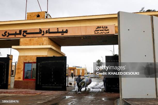 Palestinian passenger going back to the Gaza Strip walks carrying belongings at the Egyptian side of the Rafah border crossing, in the northeastern...