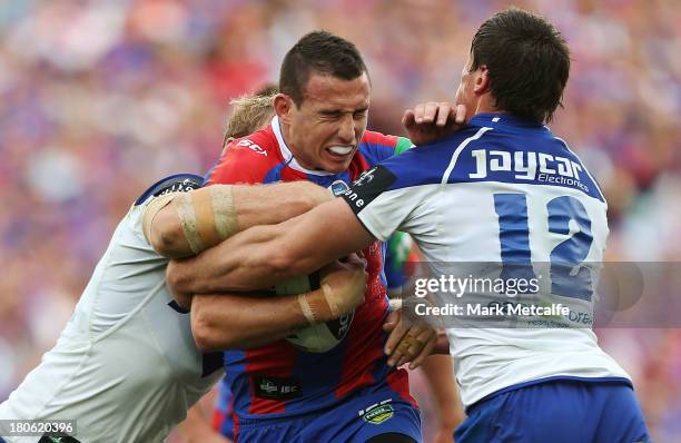 Darius Boyd of the Knights is tackled during the NRL Elimination Final match between the Canterbury Bulldogs and the Newcastle Knights at ANZ Stadium...