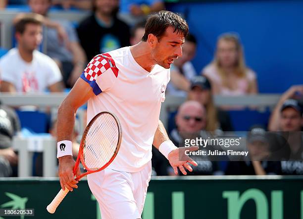 Ivan Dodig of Croatia reacts in his match against Andy Murray of Great Britain during day three of the Davis Cup World Group play-off tie between...