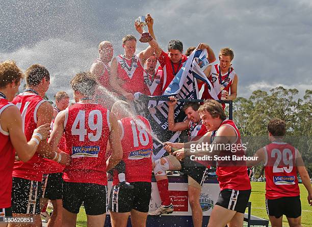 Healesville celebrate after being presented with the premiership flag and trophy after winning the Yarra Valley Mountain District Football League...