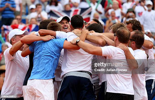 Andy Murray of Great Britain is congratulated by team mates after winning against Ivan Dodig of Croatia during day three of the Davis Cup World Group...