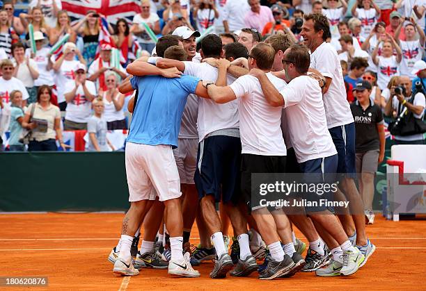 Andy Murray of Great Britain is congratulated by team mates after winning against Ivan Dodig of Croatia during day three of the Davis Cup World Group...