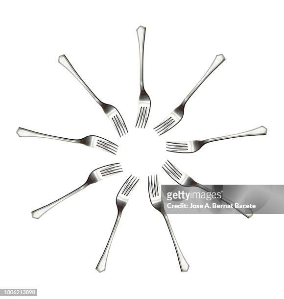 close-up cf cutlery, group of forks on a white background forming a circle. - besteck freisteller stock-fotos und bilder