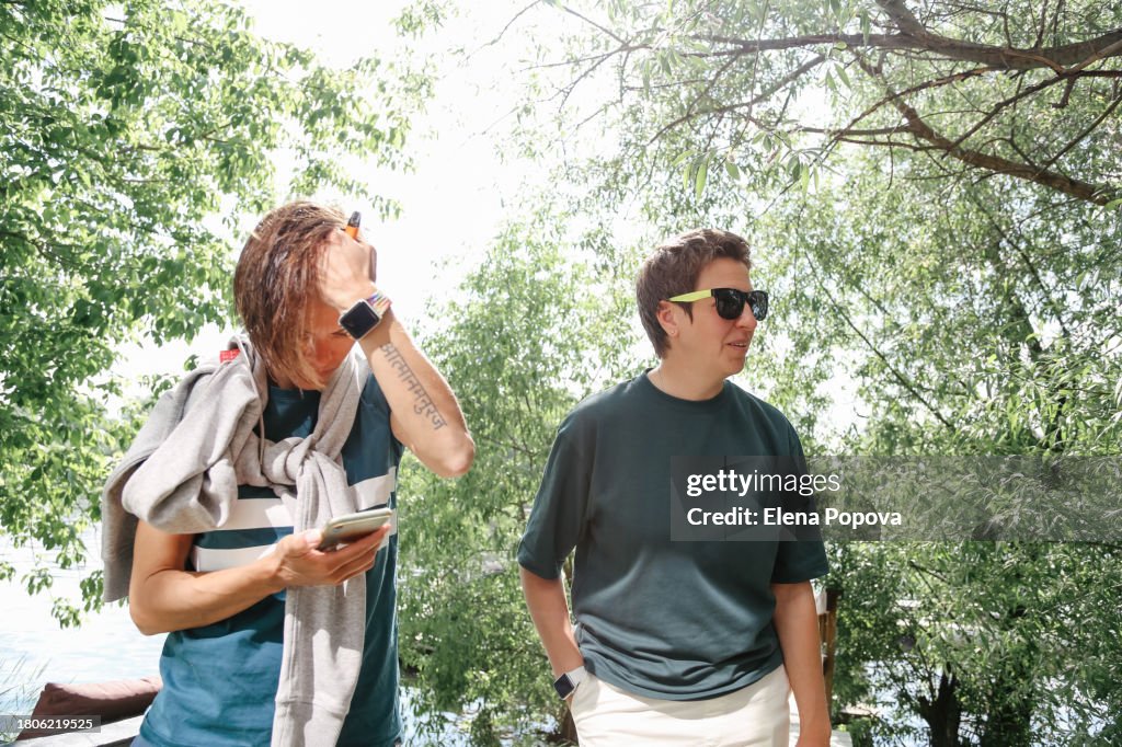 Mature Adult Surfer Women Relaxing After Wakeboard Training And Looking Data On Phone