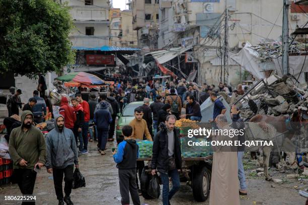 Palestinians shop in Al-Zawiya market in Gaza City on November 27 on the fourth day of a truce between Israel and Hamas. The Israeli government said...