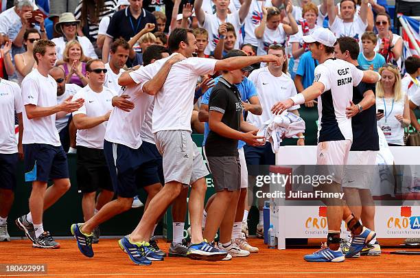 Andy Murray of Great Britain is congratulated by team mates after winning against Ivan Dodig of Croatia during day three of the Davis Cup World Group...