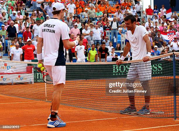 Andy Murray of Great Britain and Ivan Dodig of Croatia disscuss a line call during day three of the Davis Cup World Group play-off tie between...