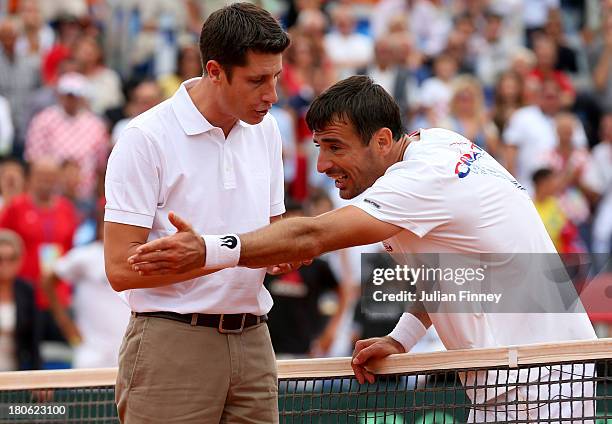 Ivan Dodig of Croatia argues a line call against Andy Murray of Great Britain during day three of the Davis Cup World Group play-off tie between...